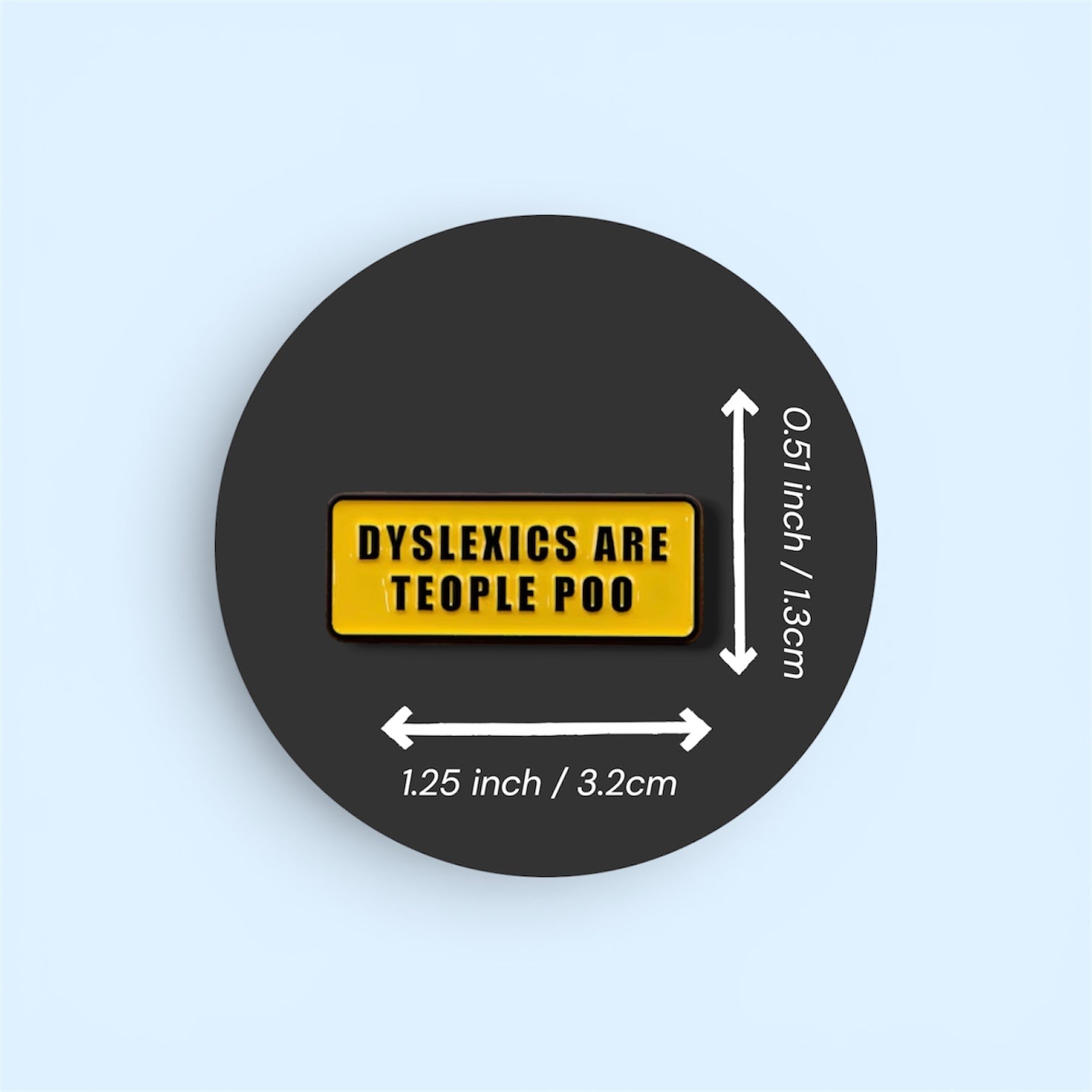 Round black sticker with yellow label stating 'Dyslexics are teople poo' on a light blue background